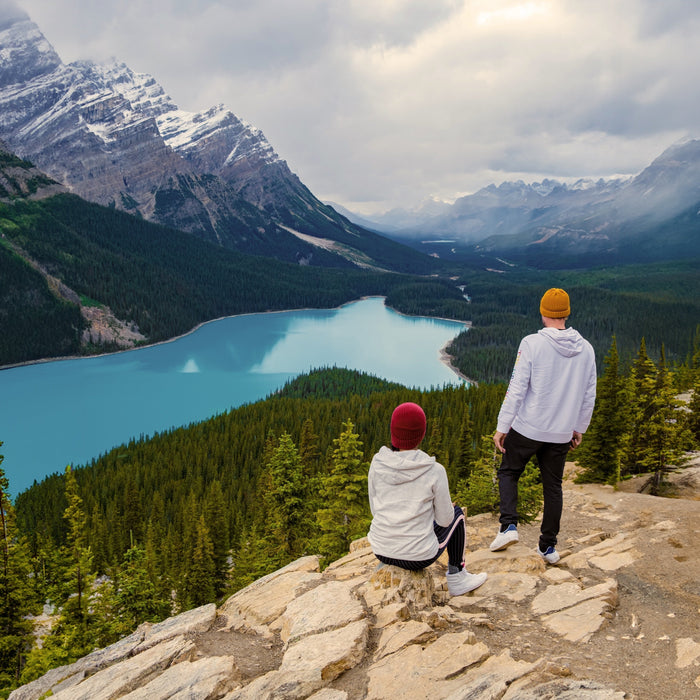 Two hikers overlooking a lake in a national park in Canada.